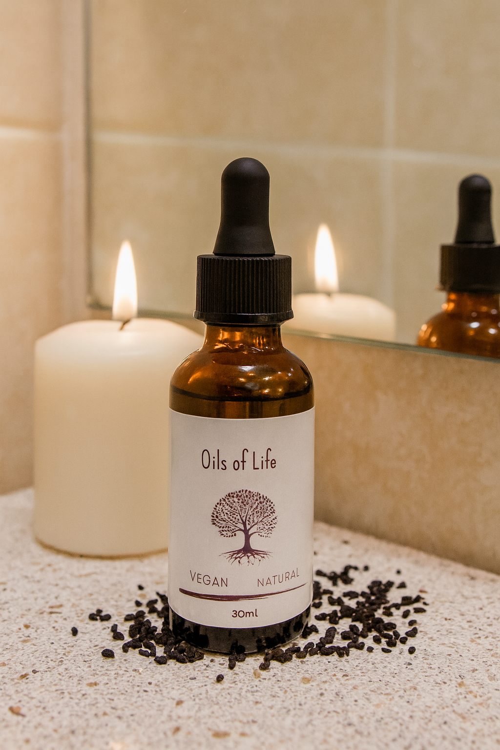Sesame seeds, rosehips, and black seeds displayed beside the Restorative Face & Body Oil bottle.