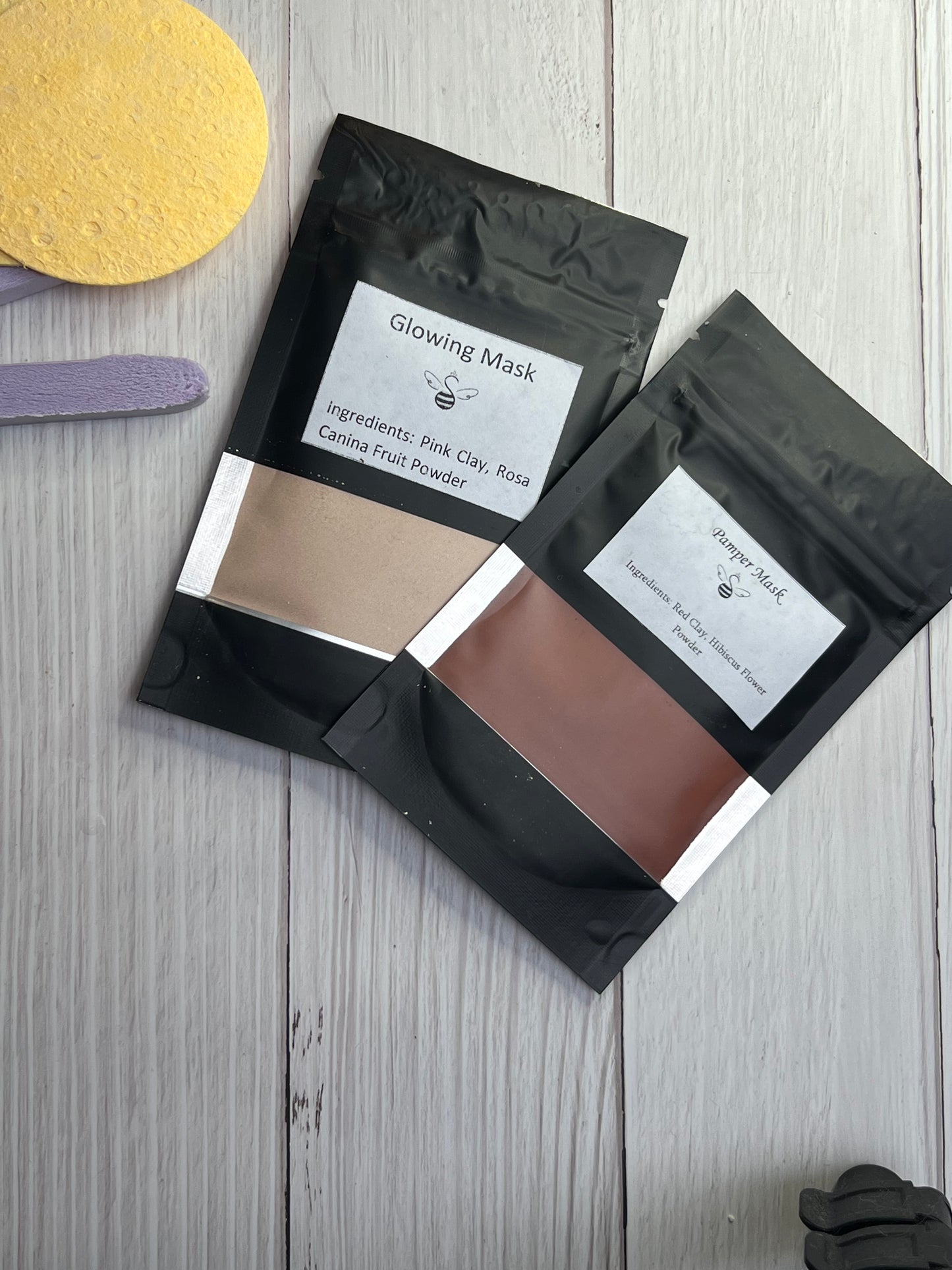 Powdered clay and green tea skincare mask in black pouches with ingredients.