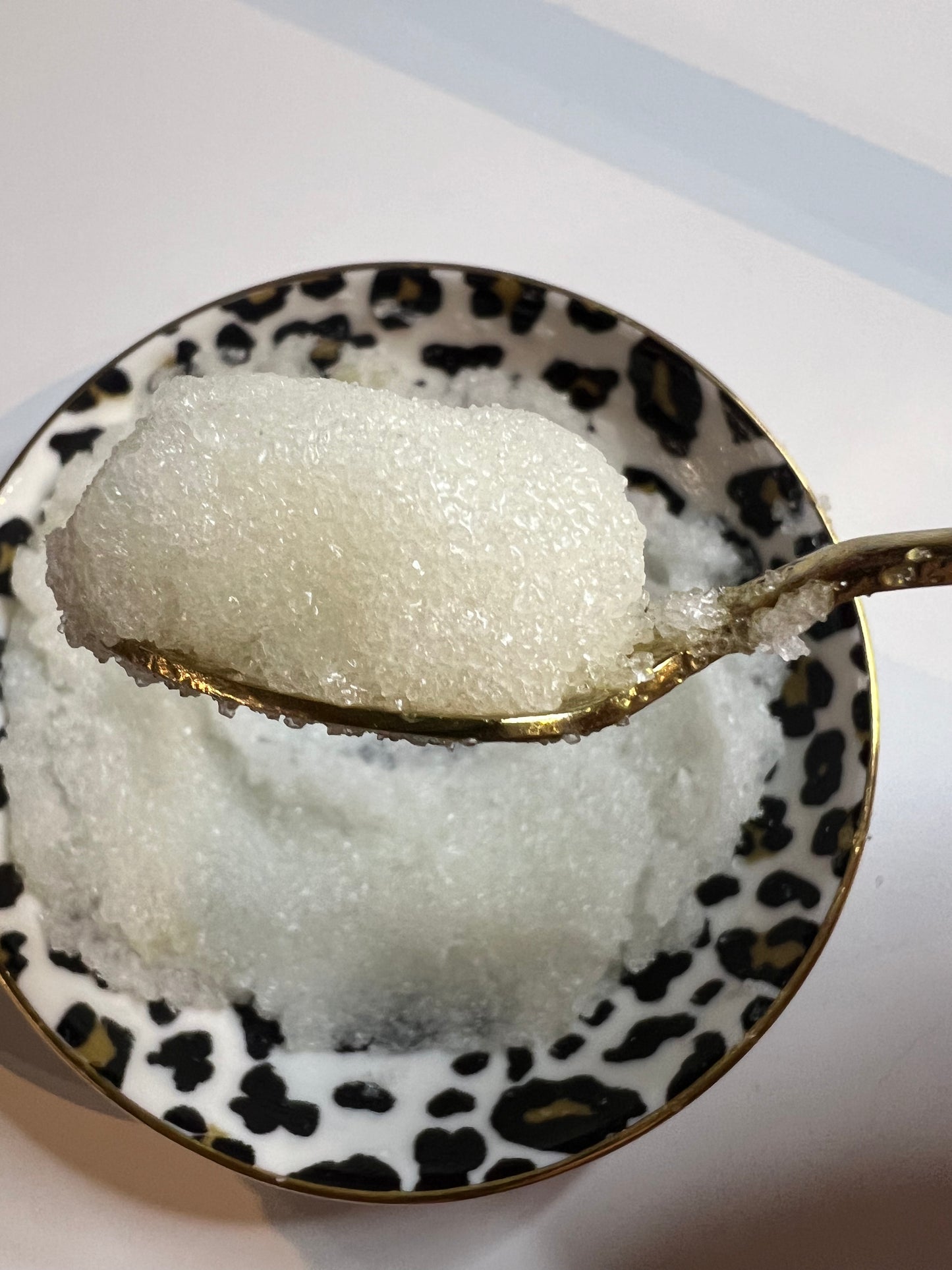 Exfoliating lip scrub texture shown on spoon – nourishing blend for soft lips