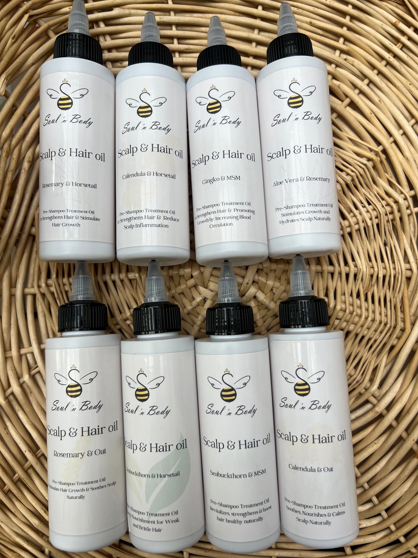 Multiple bottles of Soul n Body Pre-Shampoo Hair & Scalp Oil arranged in rows on a woven basket surface.