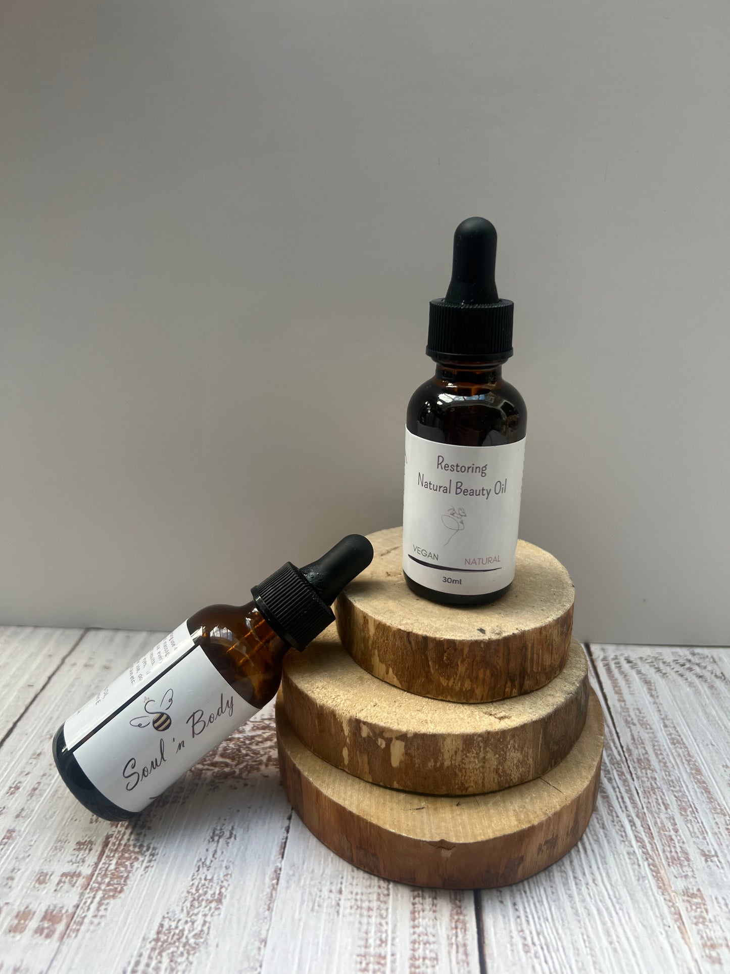 Luxury hydrating skin oil in an amber glass bottle with dropper cap, designed to soften and rejuvenate skin from head to toe.