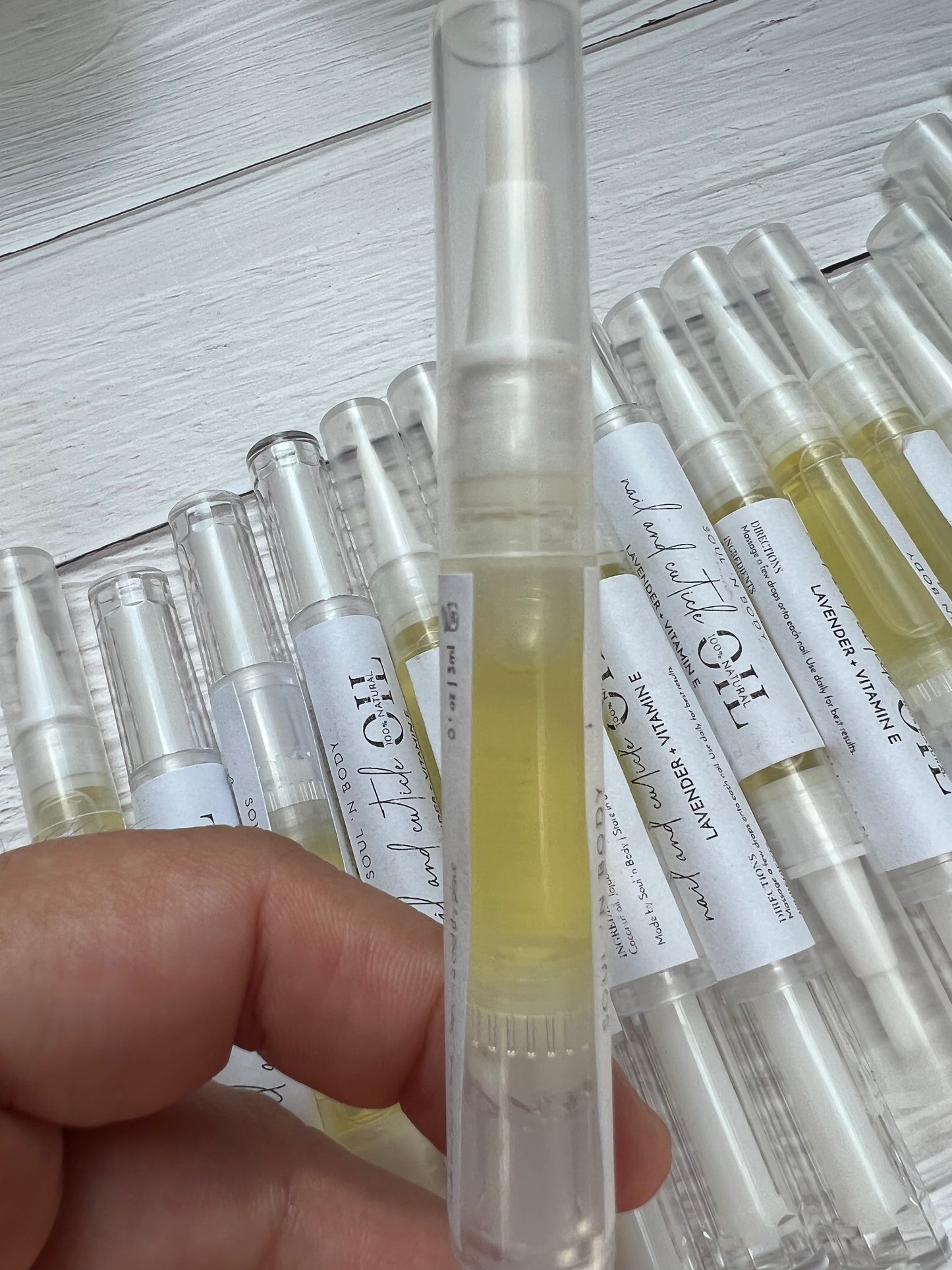 nail and cuticle oil twist pen hold up and showed a closer look