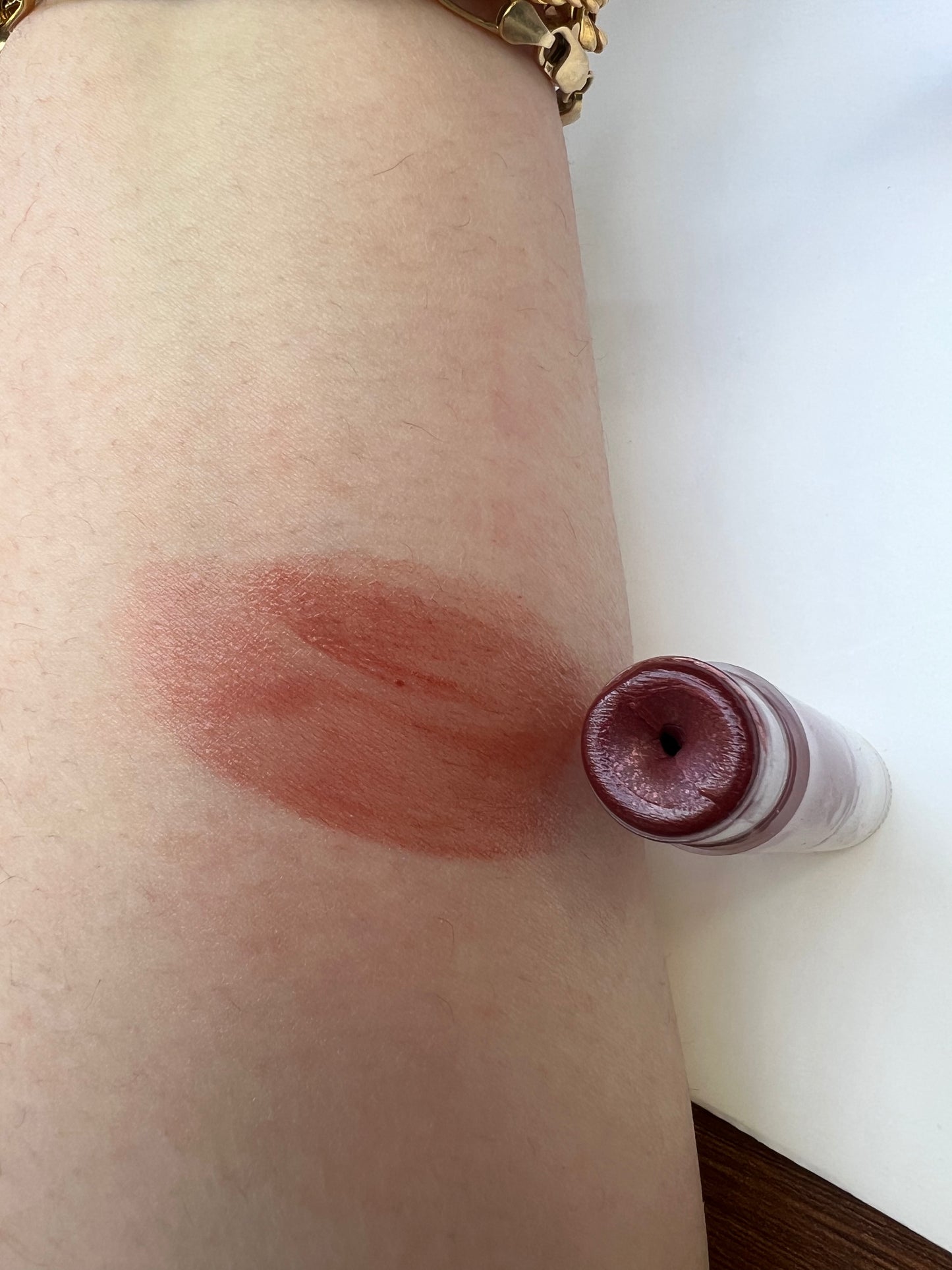Sangria lip balm swatch on skin — smooth, sheer tint with natural glow.