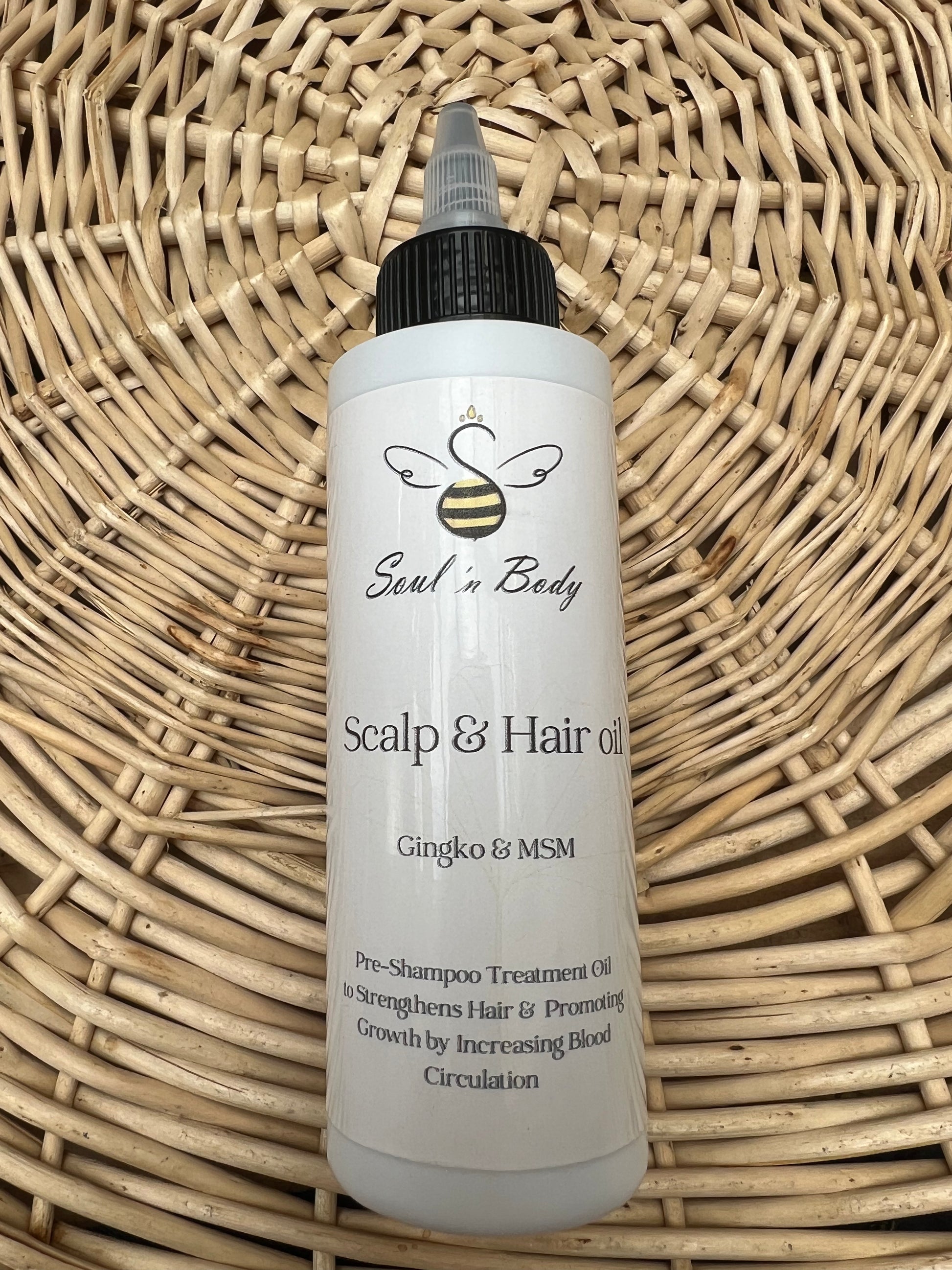 Soul n Body Pre-Shampoo Hair & Scalp Oil bottle displayed on a round woven basket mat.