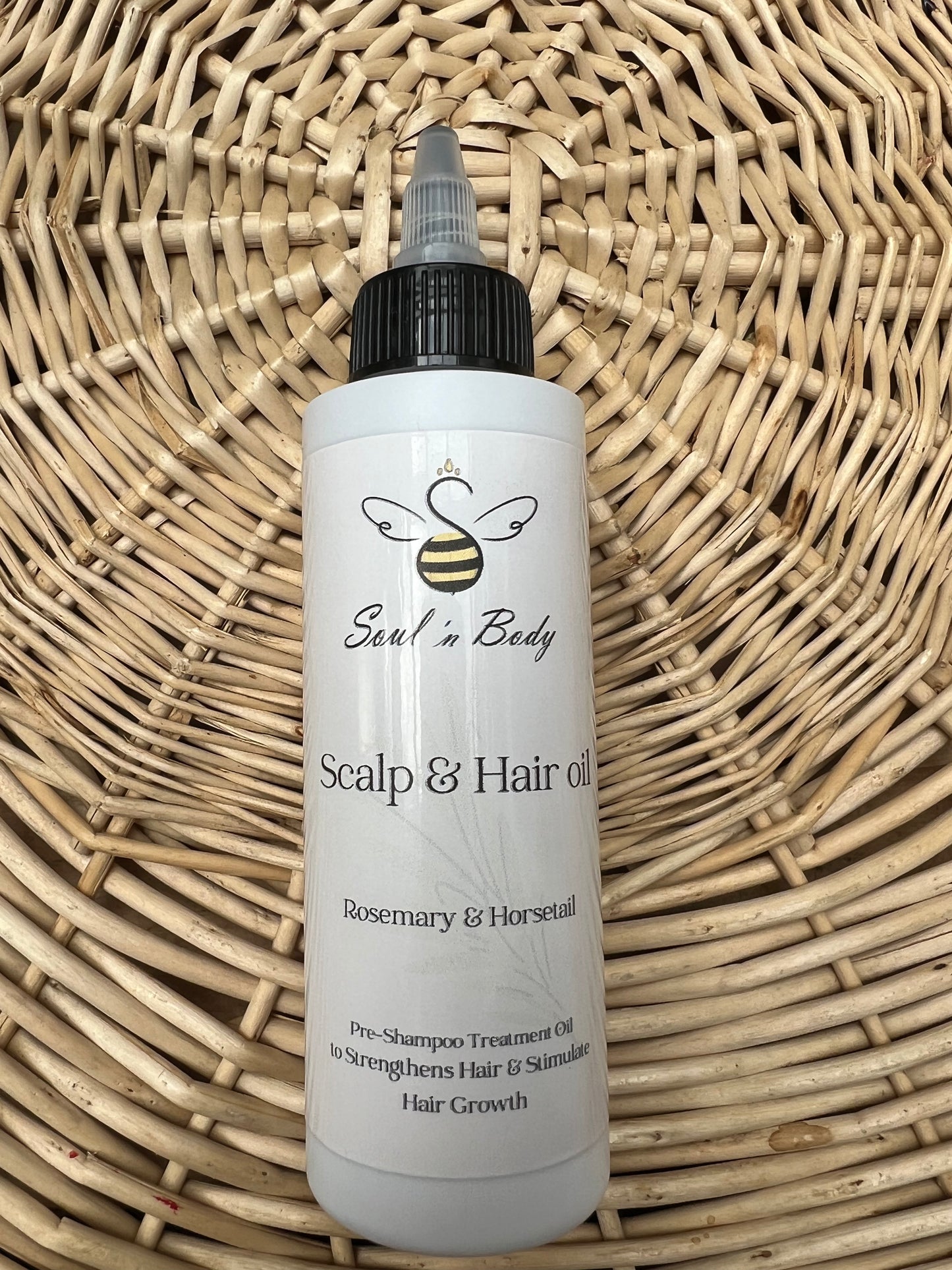 Bottle of Rosemary & Horsetail Scalp & Hair oil from Soul n Body on a wicker background