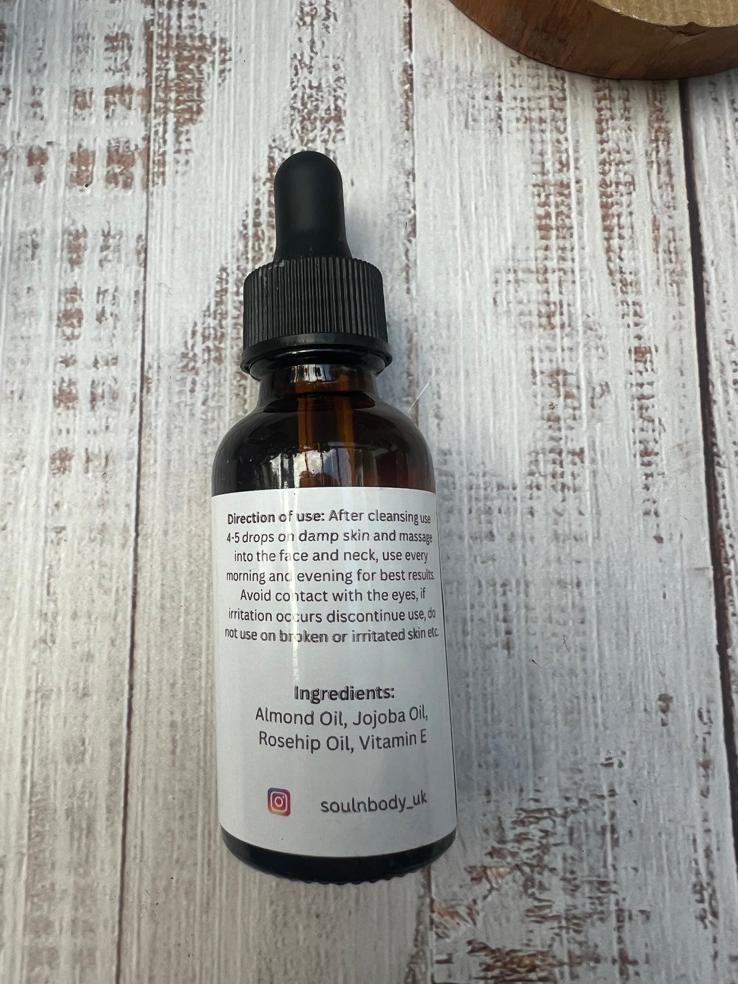 the back of a face and body oil bottle with rosehip oil