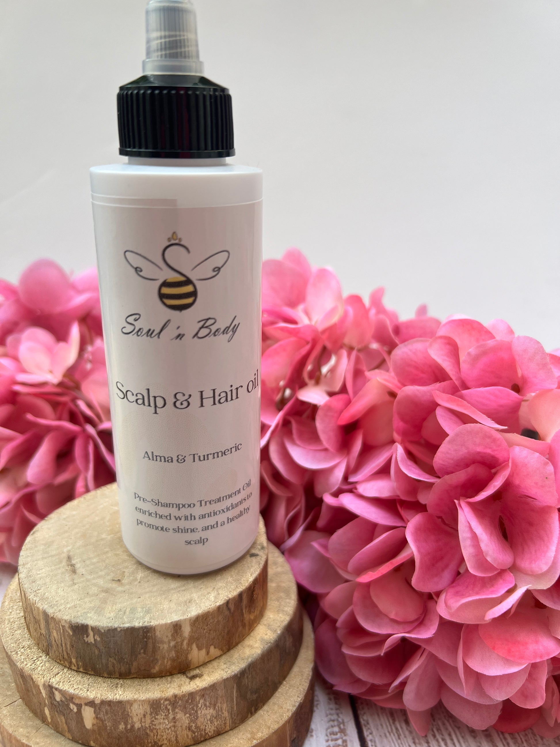 Flat lay of pre-shampoo hair oil with amla and turmeric