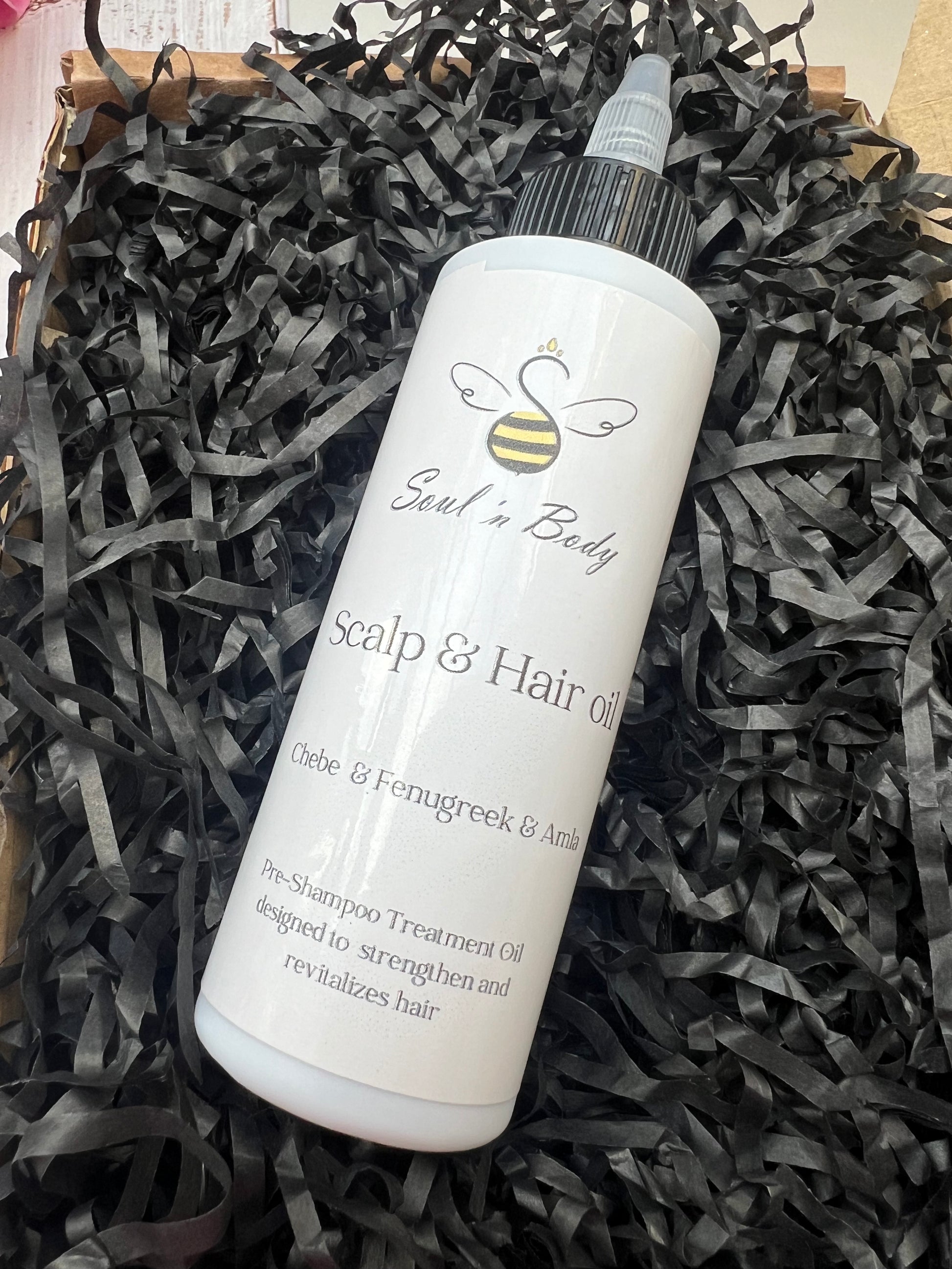 Handmade herbal hair oil infused with traditional African and Ayurvedic ingredients