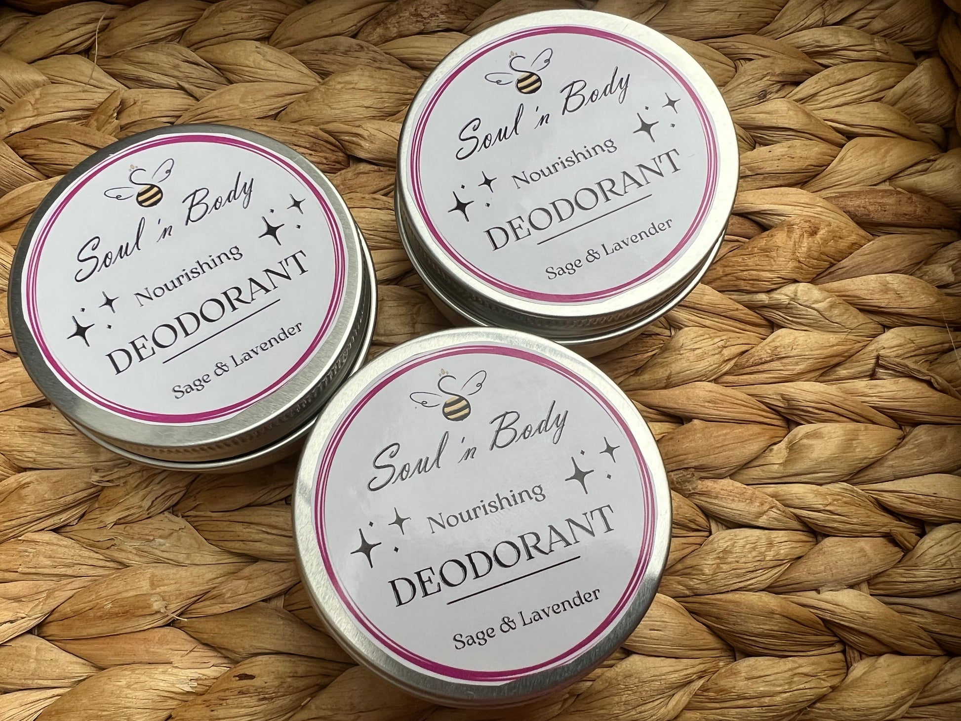 Three tins of 'Soul in Body' nourishing deodorant on a woven mat.