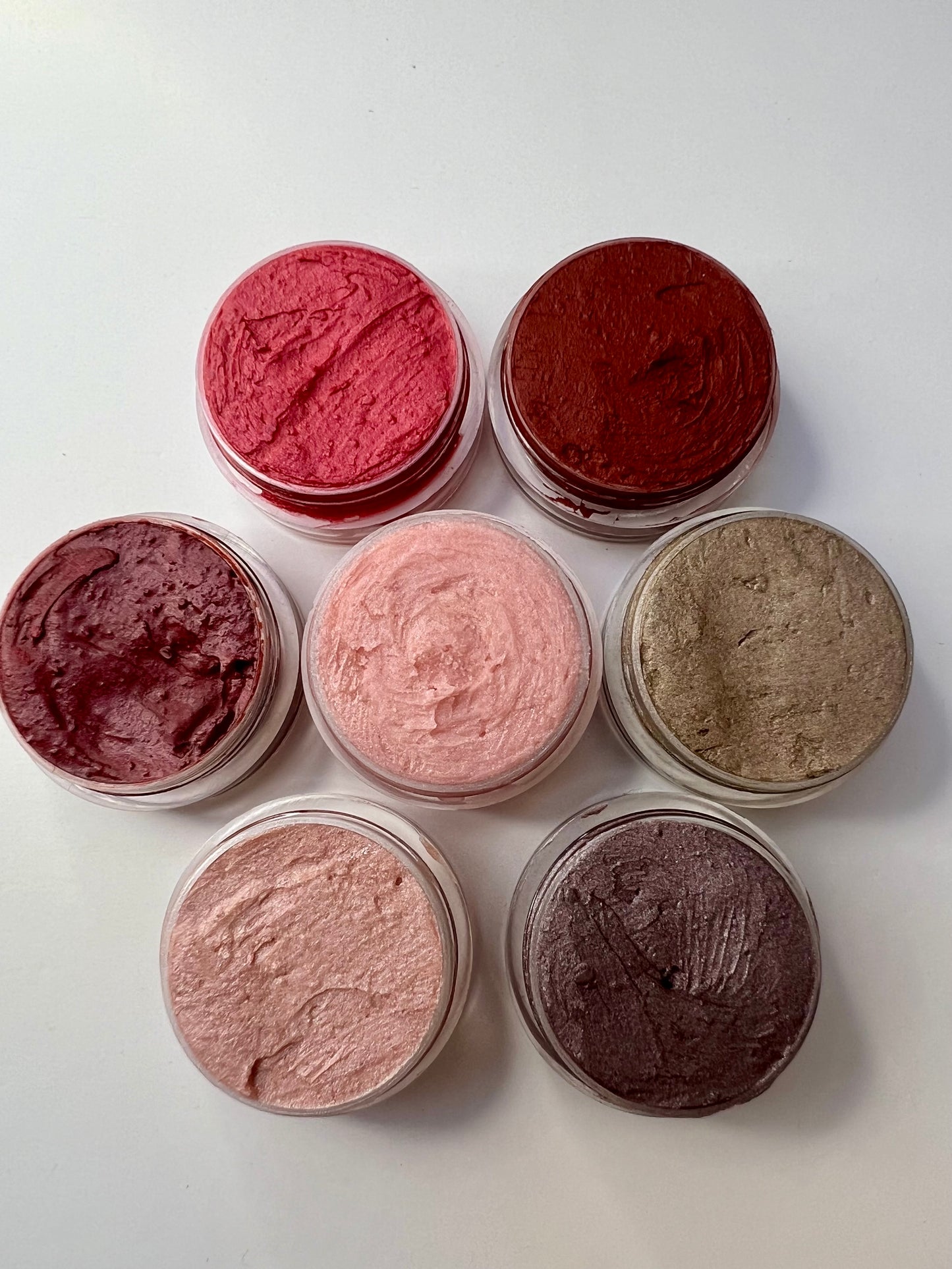 assorted tins of handmade natural lip balms with different tints