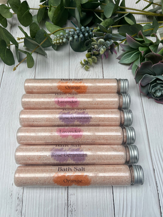 Handmade bath salt tubes with natural essential oils – relaxing spa gift set displayed with greenery