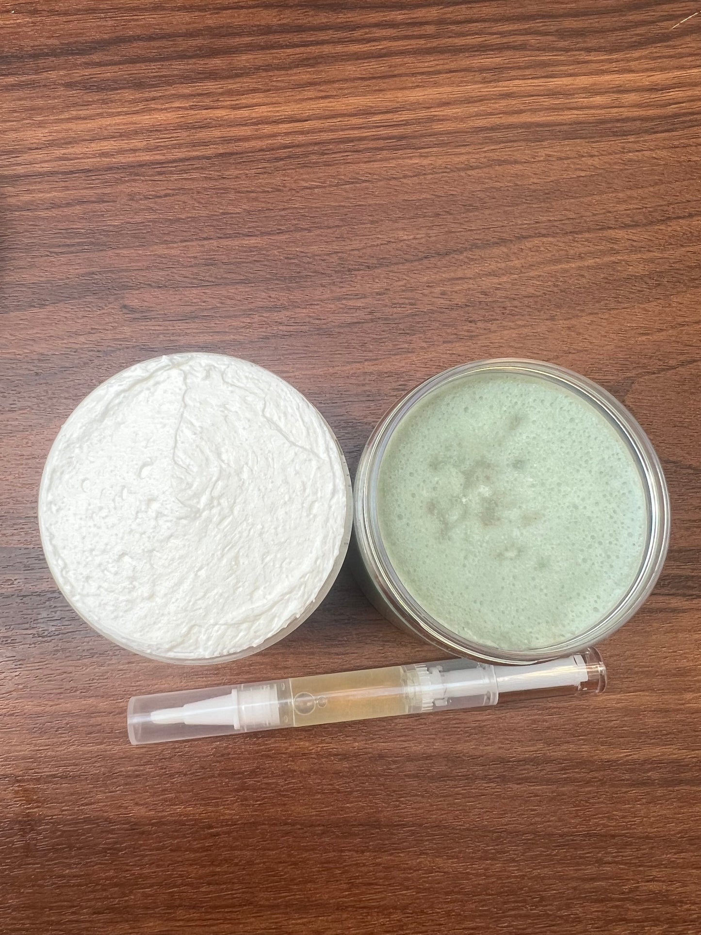 Two containers of cosmetic products on a wooden surface
