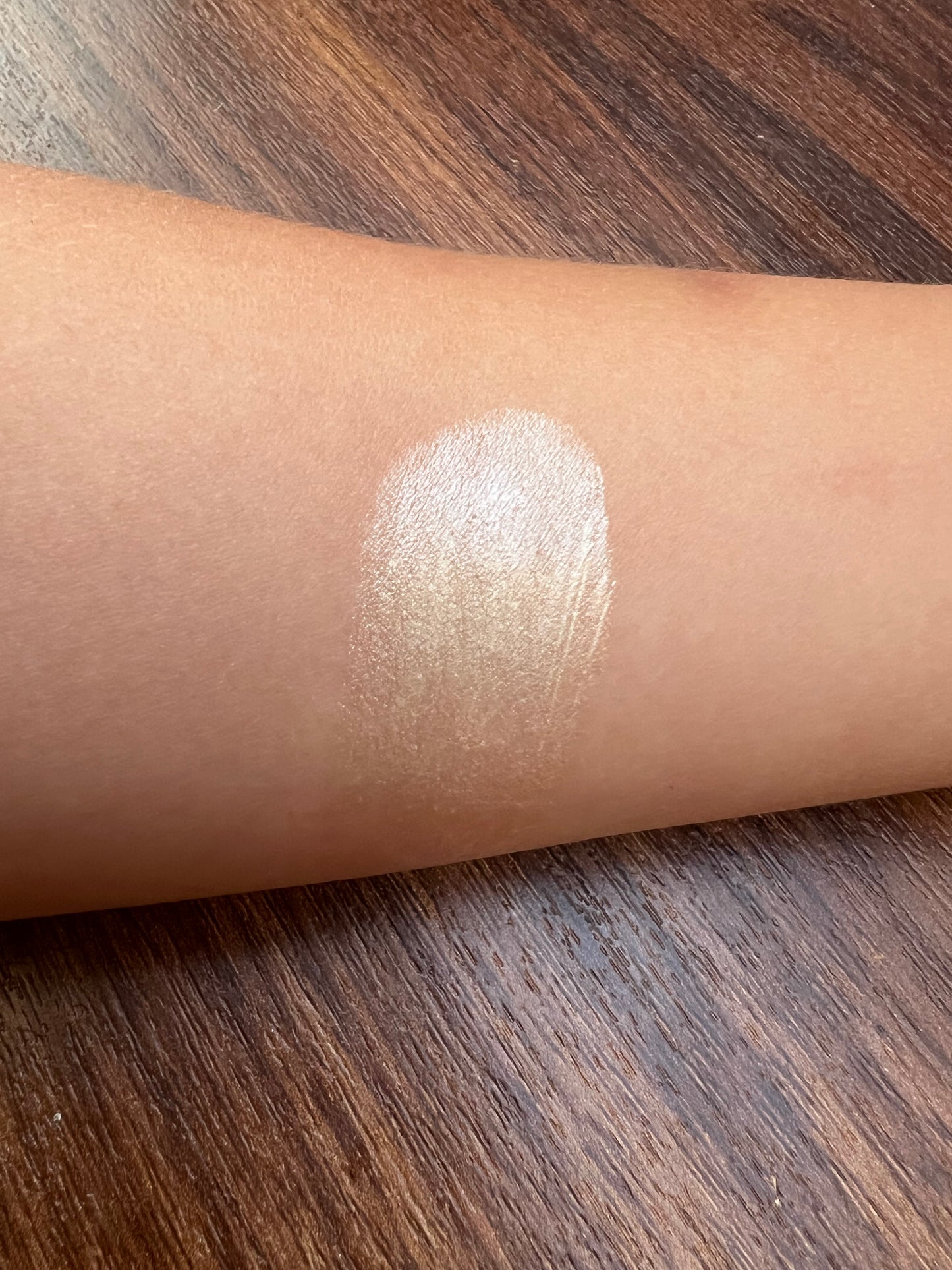 Close-up swatch of Golden Hour natural tinted lip balm on skin showing iridescent pearl shimmer – limited edition handmade lip care UK