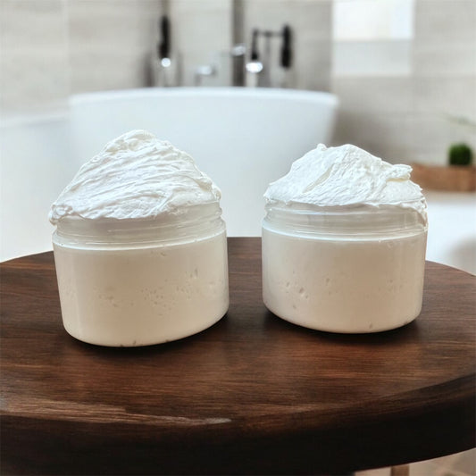 Two jars of whipped toddler body butter on wooden table