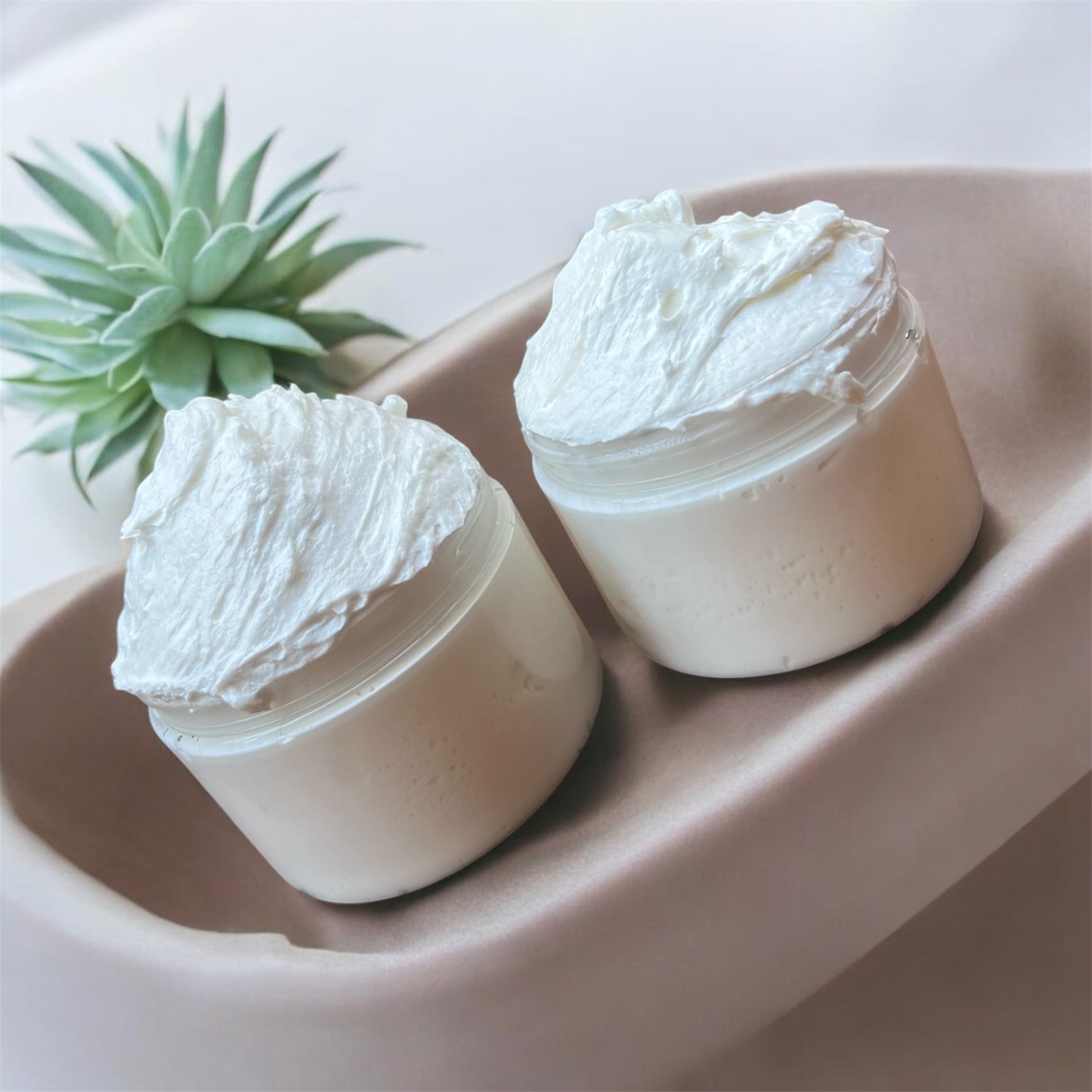 Open jar of creamy cocoa and shea butter moisturiser