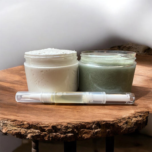 natural foot care set with whipped butter, green exfoliating scrub, and nourishing nail oil on wooden board.