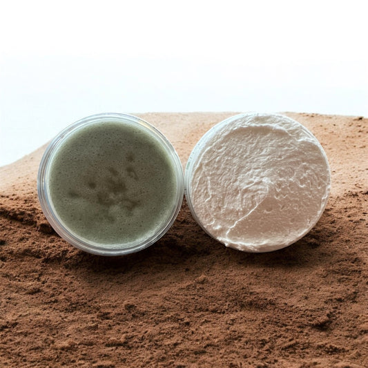 foot scrub and whipped foot butter on a sandy surface
