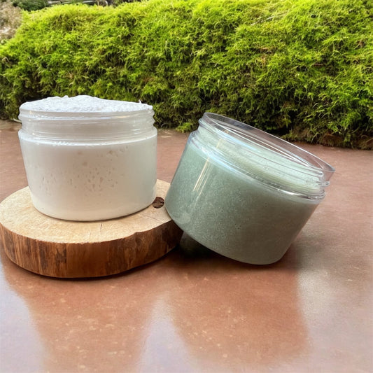 Foot Scrub and Whipped Foot Butter in jars on a wooden stand – natural exfoliating and moisturizing foot care set.